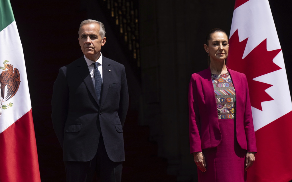Canada's Prime Minister Mark Carney and Mexican President Claudia Sheinbaum stand on the podium during an official welcome ceremony at the National Palace in Mexico City, Thursday, Sept. 18, 2025. (Adrian Wyld/The Canadian Press via AP)
