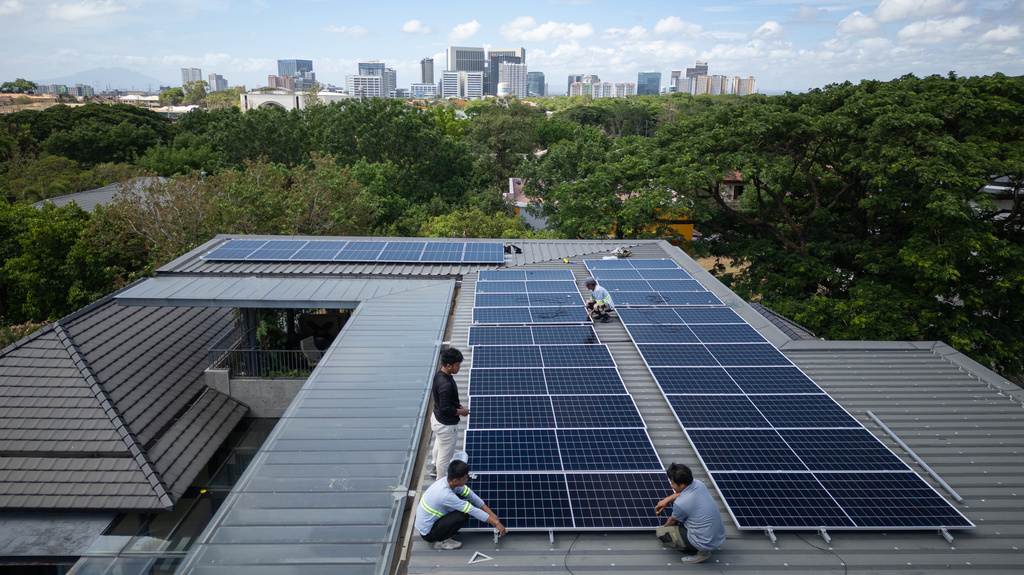 A team of solar installers set up a new rooftop solar system at a home in Manila, Philippines, on May 1, 2026. (AP Photo/Anton L. Delgado)