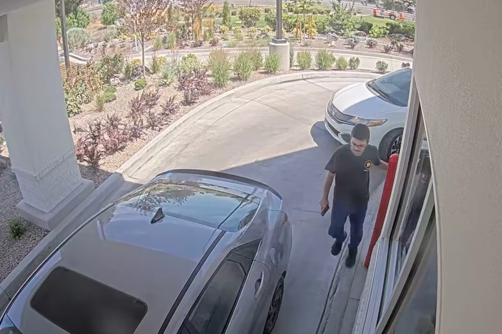 This image taken from video provided by the Twin Falls Police Department shows Chad Williams holding a gun and approaching a car in an In-N-Out drive-thru Saturday, Aug. 1, 2026, in Twin Falls, Idaho (Twin Falls Police Department via AP)