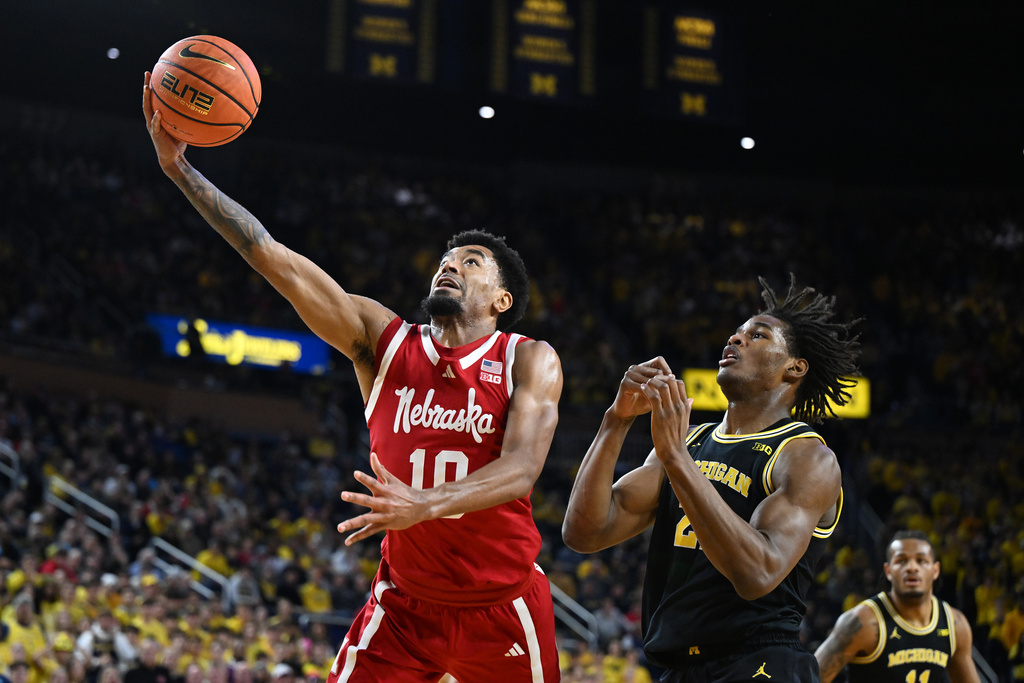 Nebraska guard Jamarques Lawrence (10) shoots the ball against Michigan forward Morez Johnson Jr. (21) in the first half of an NCAA college basketball game in Ann Arbor, Mich., Tuesday, Jan. 27, 2026. (AP Photo/Lon Horwedel)