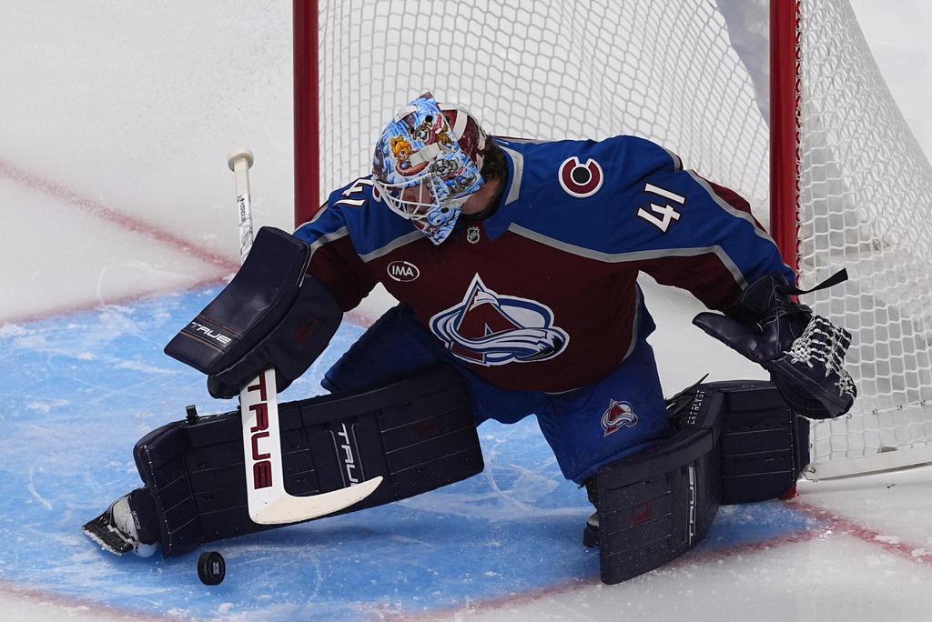 Colorado Avalanche goaltender Scott Wedgewood stops a shot in the first period of an NHL hockey game against the Utah Mammoth, Thursday, Oct. 9, 2025, in Denver. (AP Photo/David Zalubowski)