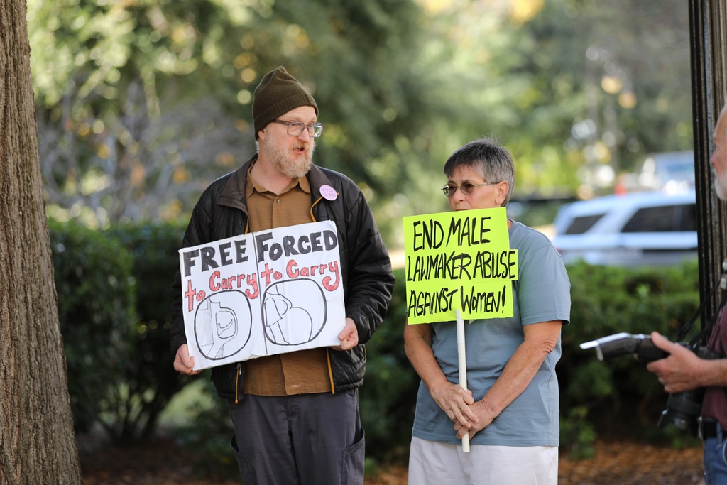 Protestors stand outside the Gressette Building for a South Carolina Senate subcommittee on a bill that would ban almost all abortions on Tuesday, Nov. 18, 2025, in Columbia, S.C. (AP Photo/Jeffrey Collins)