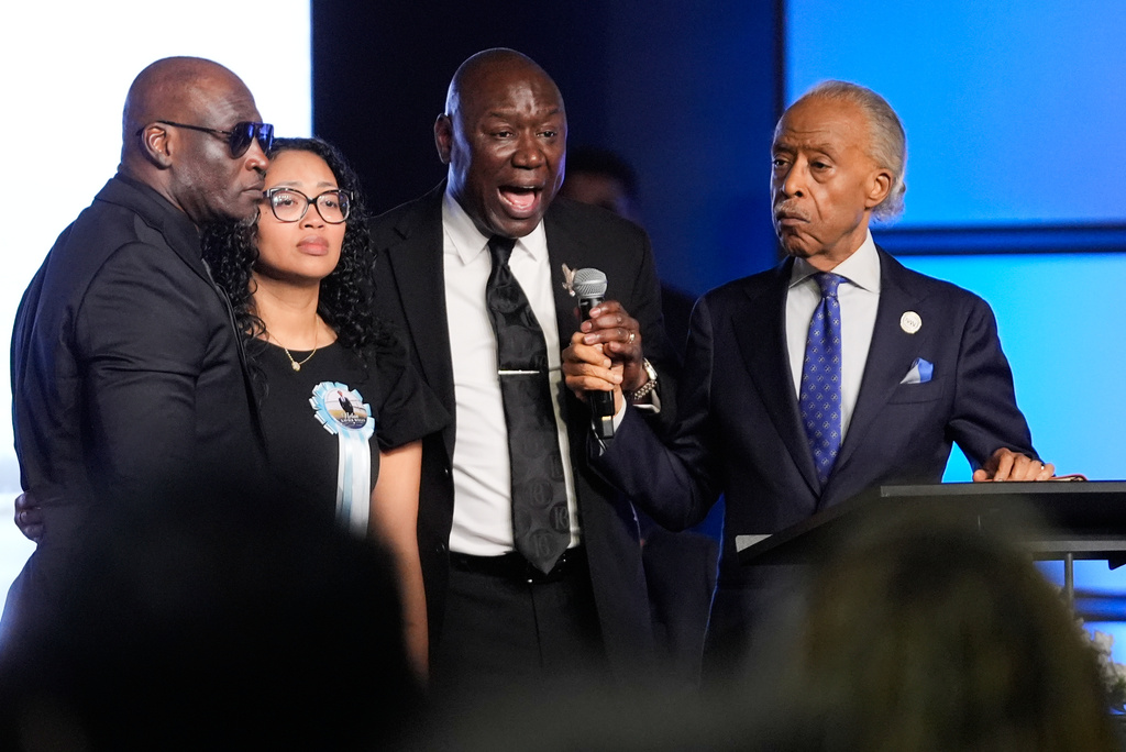 Attorney Ben Crump, center, speaks next to Elmore and Christine Wonsley, at left, and Rev. Al Sharpton during a memorial service for Nolan Xavier Wells, an 18-year-old found dead after taking a July 4 boat trip with friends, Monday, July 20, 2026, in Ocean Springs, Miss. (AP Photo/Gerald Herbert)