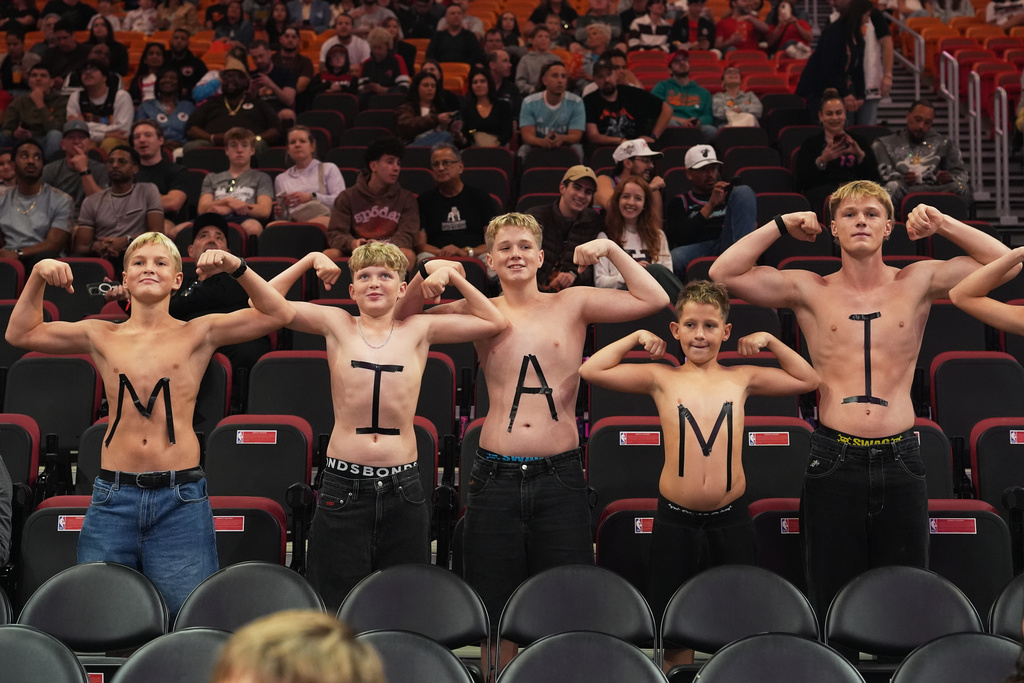 Fans pose for a photo before an NBA basketball game between the Miami Heat and the Indiana Pacers, Saturday, Dec. 27, 2025, in Miami. (AP Photo/Lynne Sladky)