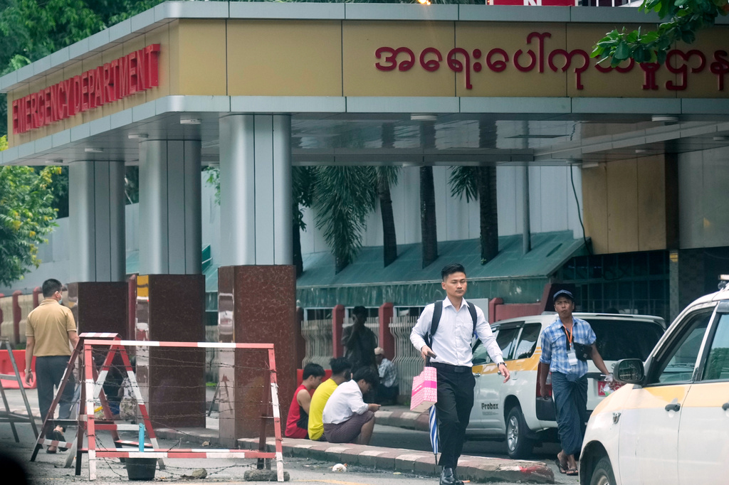 People gather at the entrance of emergency department of Yangon general hospital, Friday, Aug.14, 2026, in Yangon, Myanmar. (AP Photo/Thein Zaw)