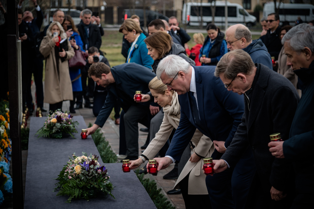 In this photo provided by the Ukrainian Foreign Ministry Press Office, High Representative of the European Union for Foreign Affairs and Security Policy Kaja Kallas, center left, Ukraine's Foreign Minister Andrii Sybiha, center right, and EU foreign ministers attend a commemorating ceremony in Bucha, Ukraine, Tuesday, March 31, 2026. (Ukrainian Foreign Ministry Press Office via AP)