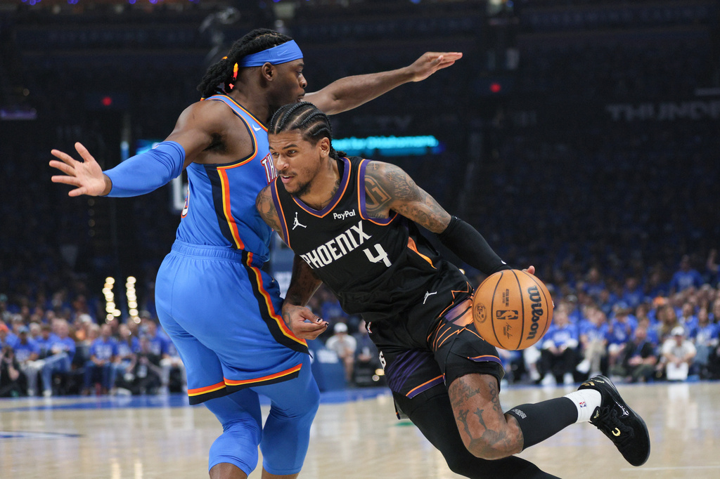 Phoenix Suns guard Jalen Green (4) drives against Oklahoma City Thunder guard Luguentz Dort, left, during the first half in Game 1 of a first-round NBA playoffs basketball series Sunday, April 19, 2026, in Oklahoma City. (AP Photo/Nate Billings)