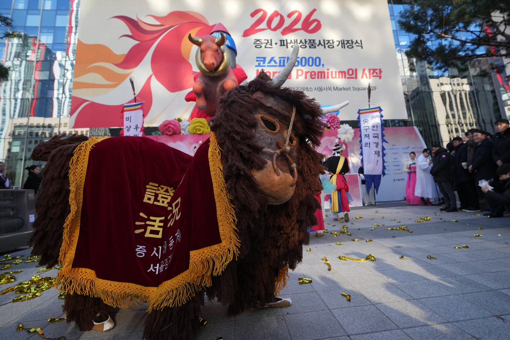 Dancers in a bull-shaped costume perform to celebrate the opening for the 2026 trading year outside of the Korea Exchange in Seoul, South Korea, Friday, Jan. 2, 2026. (AP Photo/Lee Jin-man)