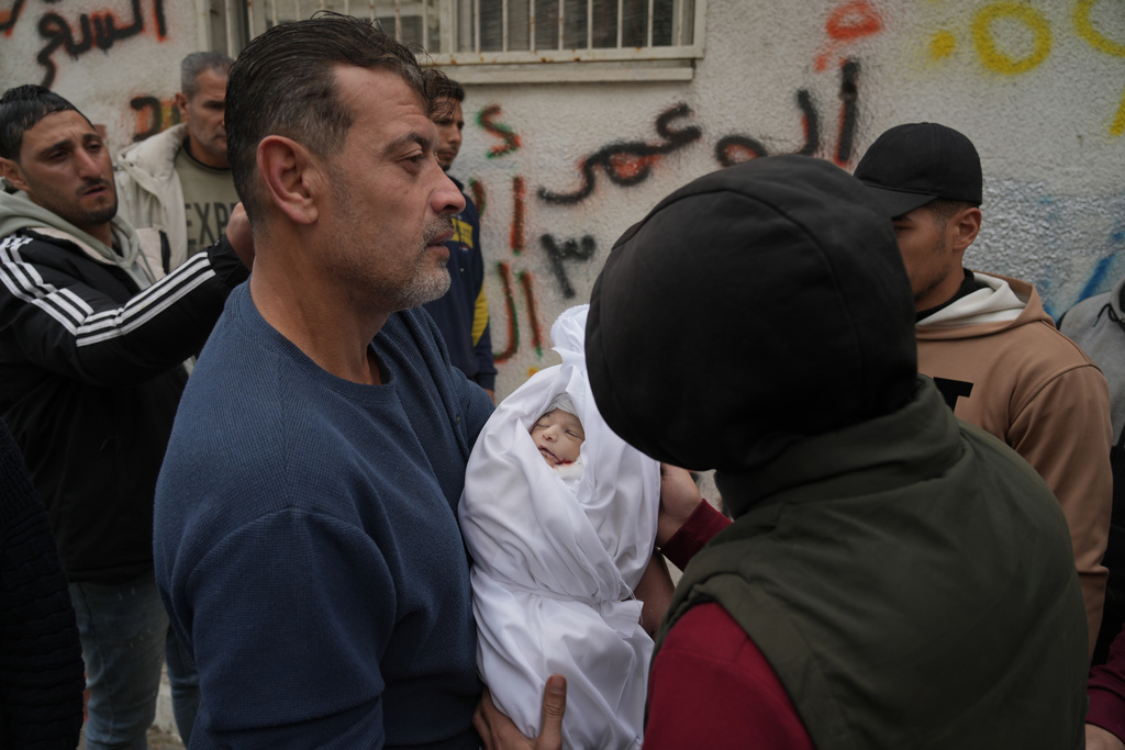 Palestinians carry 1-week-old baby Wateen al-Khabaz, who was killed in an Israeli military strike, at Shifa Hospital in Gaza City , Wednesday, Feb. 4, 2026. (AP Photo/Jehad Alshrafi)