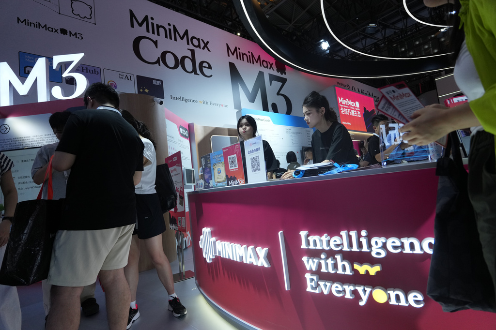 Workers station at the booth for Chinese Ai company Minimax during the World AI Conference in Shanghai, China on July 17, 2026. (AP Photo/Ng Han Guan, File)