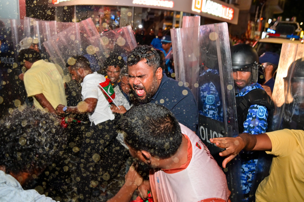 Police clash with opposition supporters during an anti-government protest in Male, Maldives, Friday, Oct, 3, 2025. (AP Photo/ Mohamed Sharhaan)
