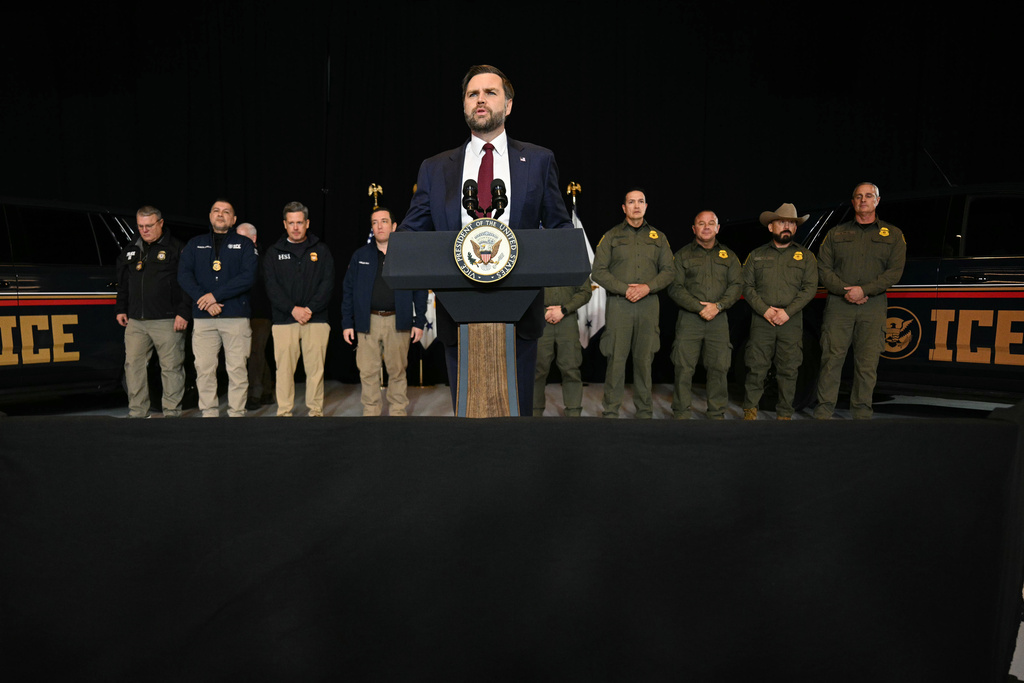 ICE vehicles sit in the background as federal immigration agents listen to US Vice President JD Vance speak at an industrial shipping facility on the administration's economic agenda and impacts on the Midwest in Toledo, Ohio, on Thursday, Jan. 22, 2026. (Jim Watson/Pool Photo via AP)