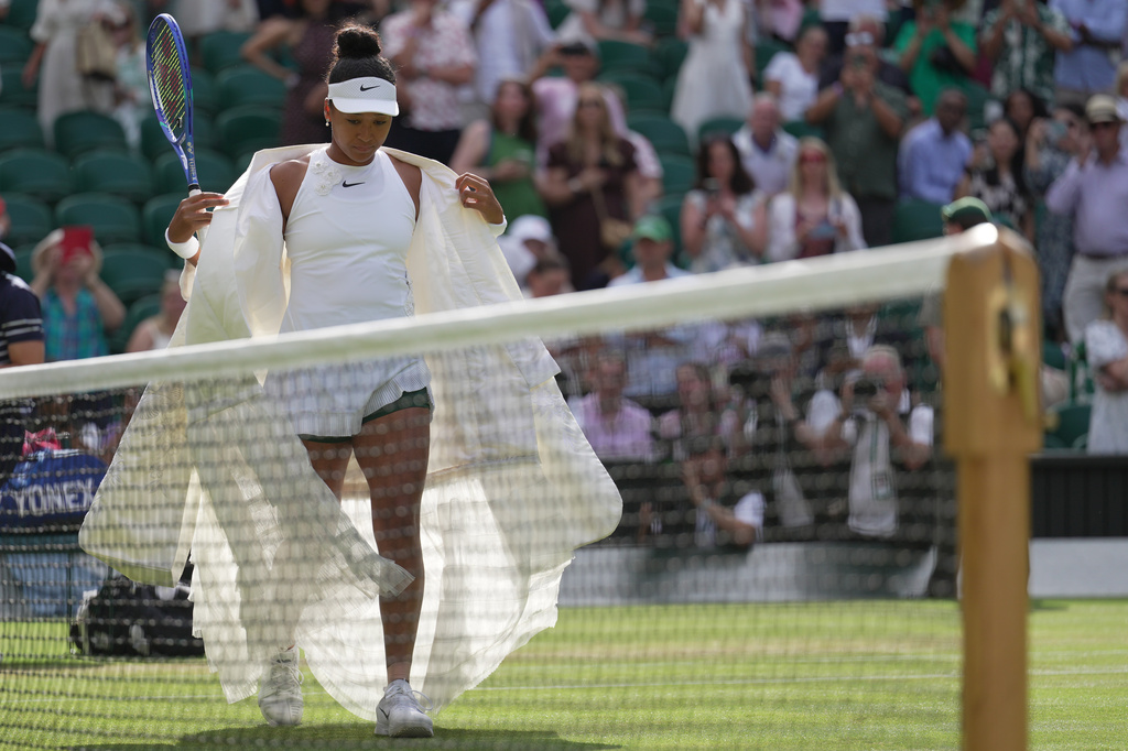 Naomi Osaka of Japan enters the centre court to play against Aryna Sabalenka of Belarus in their fourth round women's singles match at the Wimbledon Tennis Championships in London, Sunday, July 5, 2026. (AP Photo/Brian Inganga)
