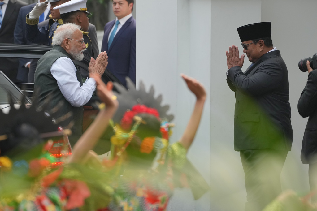 India's Prime Minister Narendra Modi, left, is greeted by Indonesia's President Prabowo Subianto as traditional dancers perform during the welcoming ceremony ahead of their meeting at Merdeka Palace in Jakarta, Indonesia, Tuesday, July 7, 2026. (AP Photo/Achmad Ibrahim)