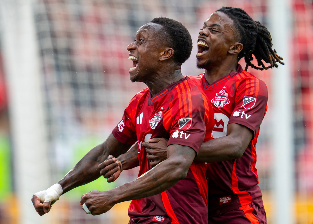 Toronto FC defender Richie Laryea, left, is congratulated by teammate Malik Henry after scoring a goal againt Austin FC during the second half of an MLS soccer game in Toronto, Saturday, April 18, 2026. (Frank Gunn/The Canadian Press via AP)