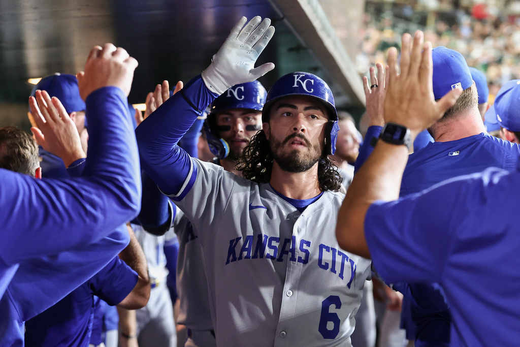 Kansas City Royals' Jonathan India celebrates in the dugout after hitting a three-run home run during the fourth inning of a baseball game against the Athletics Friday, Sept. 26, 2025, in West Sacramento, Calif. (AP Photo/Sara Nevis)