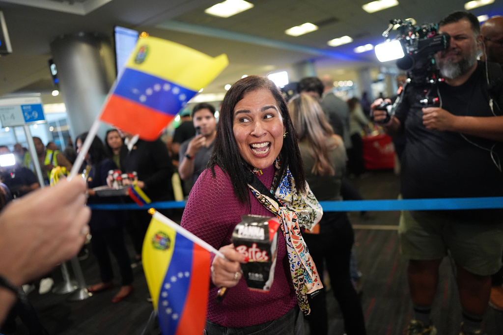 A passenger boards American Airlines Flight AA3599, the first direct commercial flight between the United States and Venezuela in seven years, Thursday, April 30, 2026, at Miami International Airport in Miami. (AP Photo/Rebecca Blackwell)