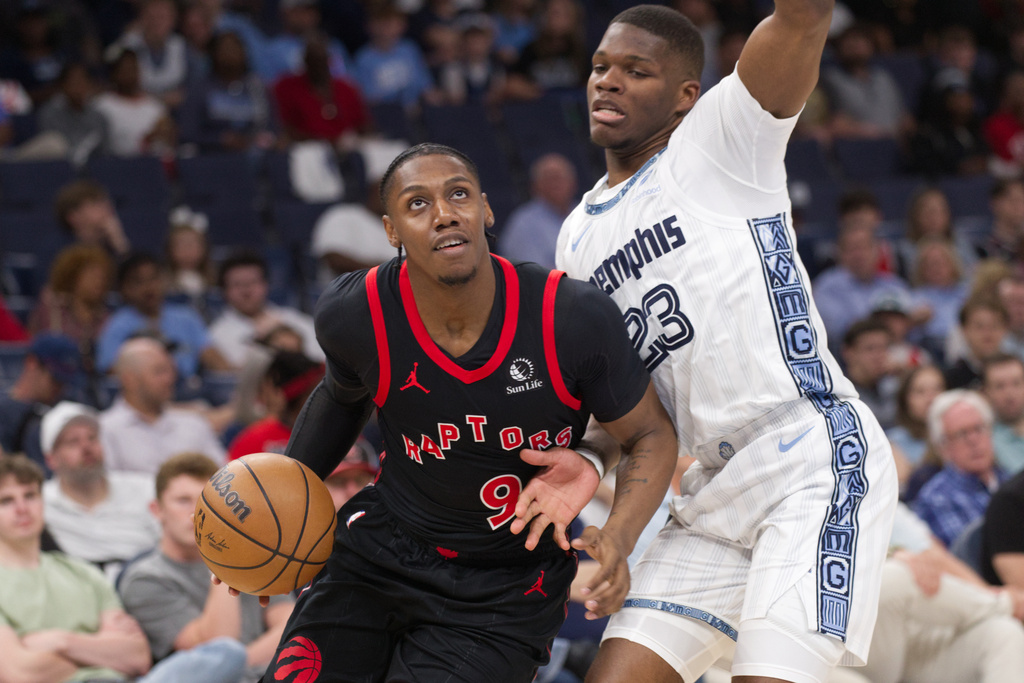 Toronto Raptors forward RJ Barrett (9) drives along the baseline while defended by Memphis Grizzlies forward Cedric Coward (23) during the first half of an NBA basketball game Friday, April 3, 2026, in Memphis, Tenn. (AP Photo/Nikki Boertman)