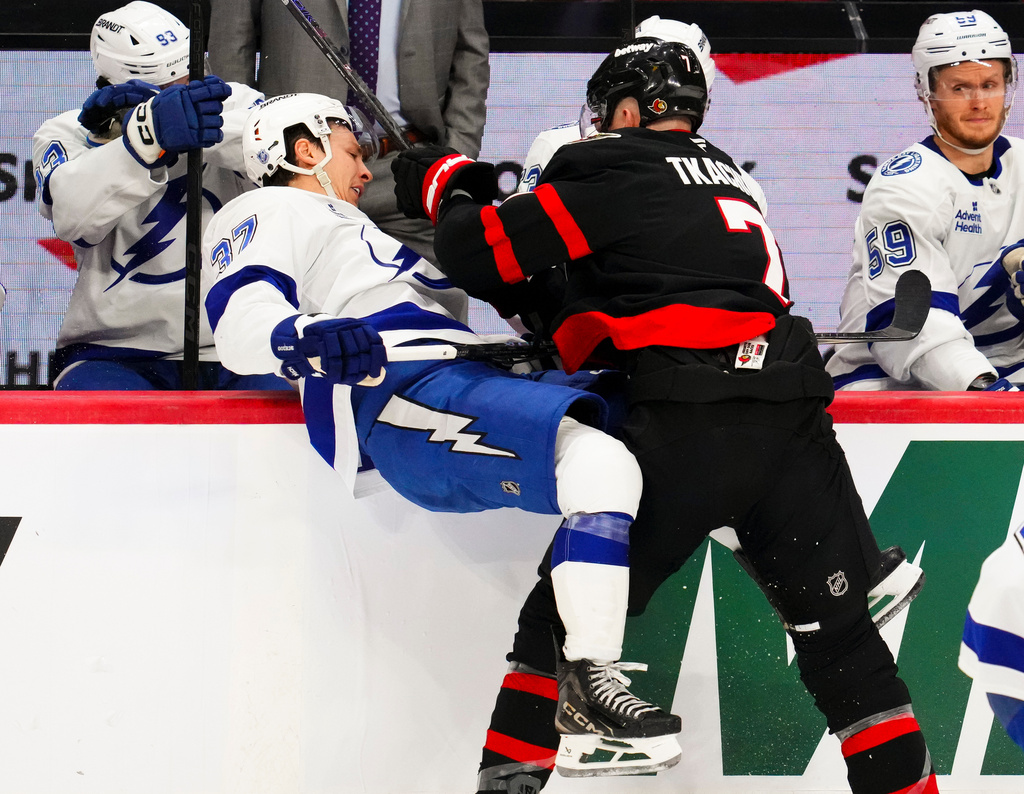 Ottawa Senators' Brady Tkachuk (7) checks Tampa Bay Lightning's Yanni Gourde (37) during the third period of an NHL hockey game in Ottawa, Ontario, on Tuesday, April 7, 2026. (Sean Kilpatrick/The Canadian Press via AP)