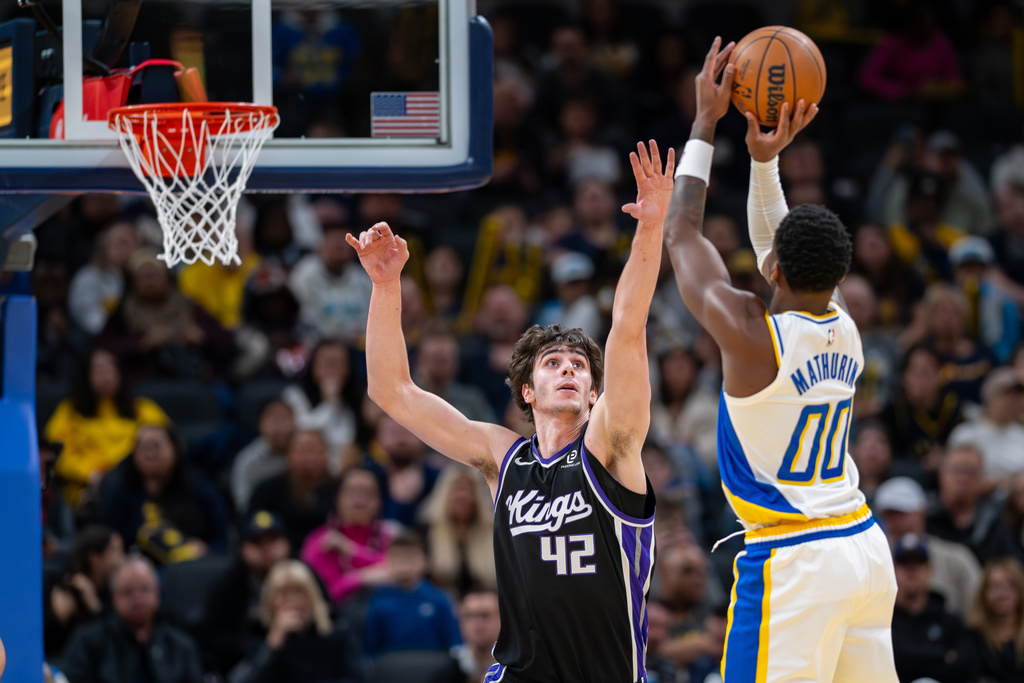 Sacramento Kings center Maxime Raynaud (42) reaches for a shot by Indiana Pacers guard Bennedict Mathurin (00) during the first half of an NBA basketball game in Indianapolis, Monday, Dec. 8, 2025. (AP Photo/Doug McSchooler)