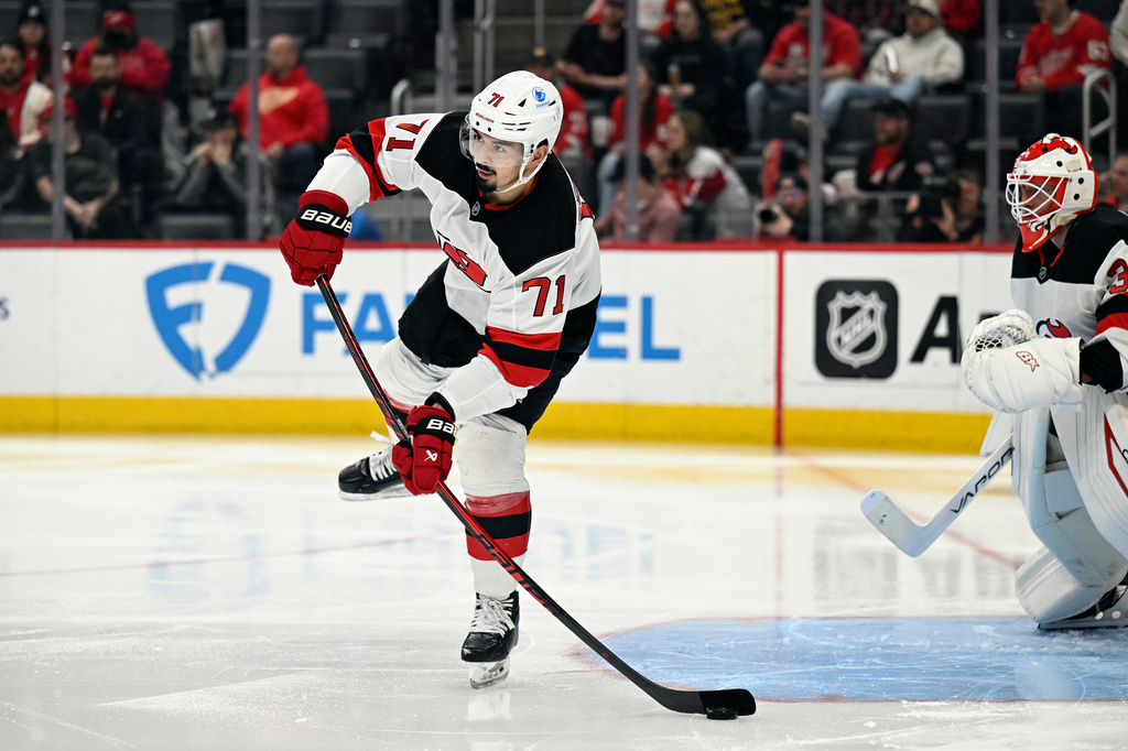 New Jersey Devils defenseman Jonas Siegenthaler passes the puck during the second period of an NHL hockey game against the Detroit Red Wings, Saturday, April 11, 2026, in Detroit. (AP Photo/Jose Juarez)