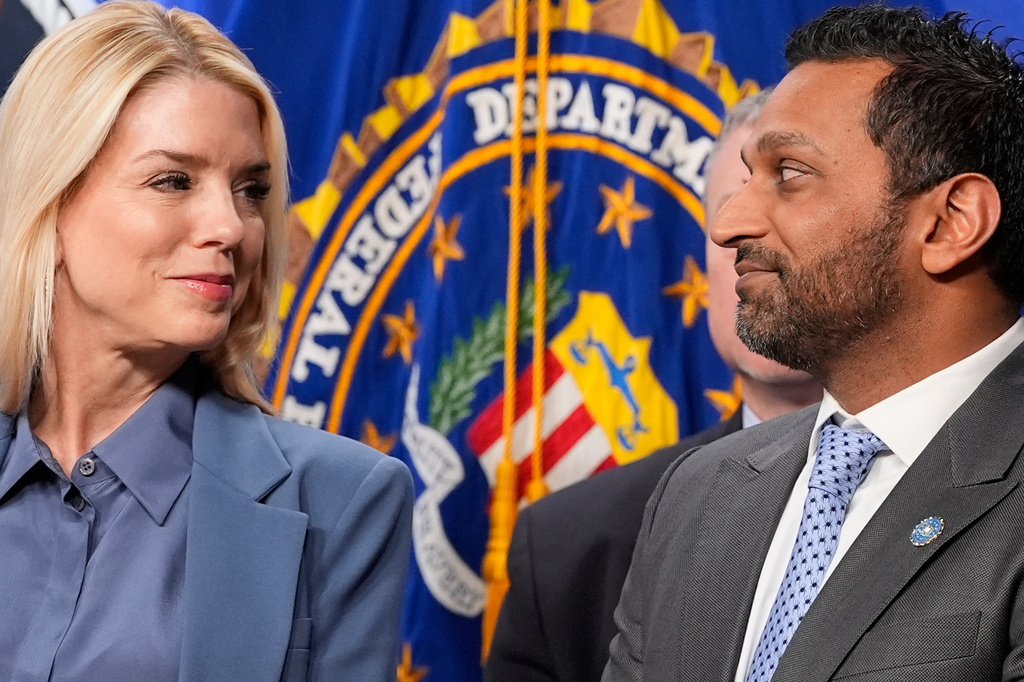 Attorney General Pam Bondi and FBI Director Kash Patel look at each other during a news conference at the Department of Justice, Thursday, Dec. 4, 2025, in Washington. (AP Photo/Alex Brandon)