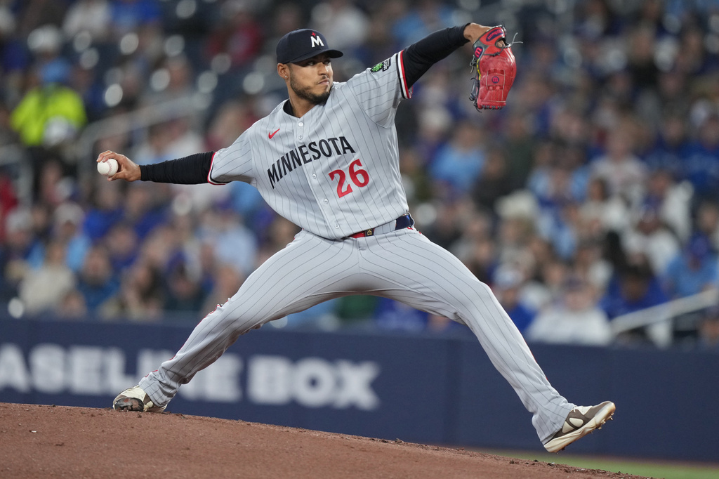 Minnesota Twins pitcher Taj Bradley throws against the Toronto Blue Jays during first-inning baseball game action in Toronto, Sunday, April 12, 2026. (Nathan Denette/The Canadian Press via AP)