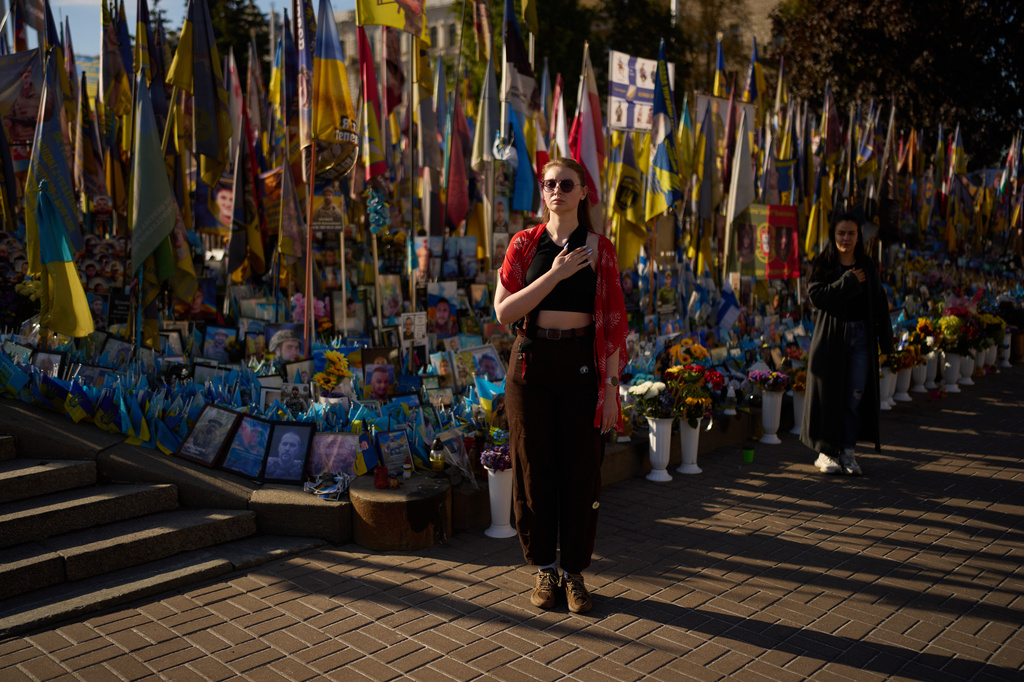Women attend a daily nationwide minute of silence in memory of soldiers killed in the war with Russia at the Independence square in Kyiv, Ukraine, Saturday, Aug. 29, 2026, marking Ukraine's Defenders Remembrance Day. (AP Photo/Francisco Seco)