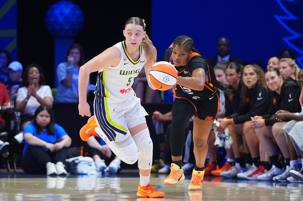 Dallas Wings guard Paige Bueckers (5) comes up with ball against Phoenix Mercury guard Kara Dunn (12) during the first half of a WNBA basketball game in Arlington, Texas, Saturday, Sept. 19, 2026. (AP Photo/LM Otero)