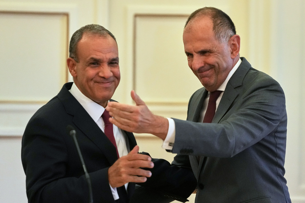 Egyptian Foreign Minister Badr Abdelatty, left, and his Greek counterpart George Gerapetritis shake hands after a news conference in Athens, Greece, Wednesday, Aug. 6, 2025. (AP Photo/Thanassis Stavrakis)
