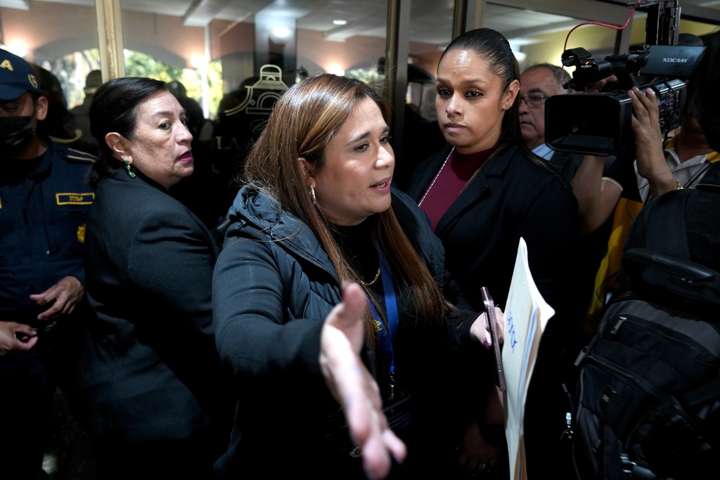 Attorney General prosecutor Leonor Morales, center, leads a raid at Club La Aurora where Bar Association members were meeting to vote for representatives to serve on the Constitutional Court, in Guatemala City, Thursday, Feb. 12, 2026.(AP Photo/Moises Castillo)