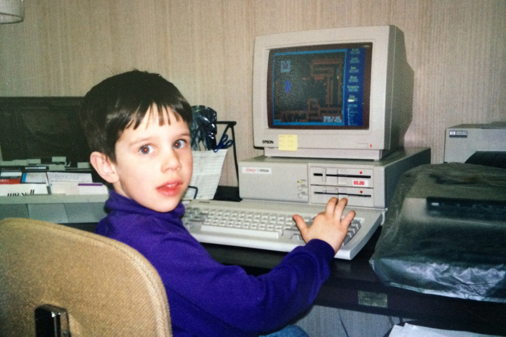 This photo provided by the family shows Kyle Bylin with a computer in Adams, N.D., in the 1990s. (Family photo via AP)