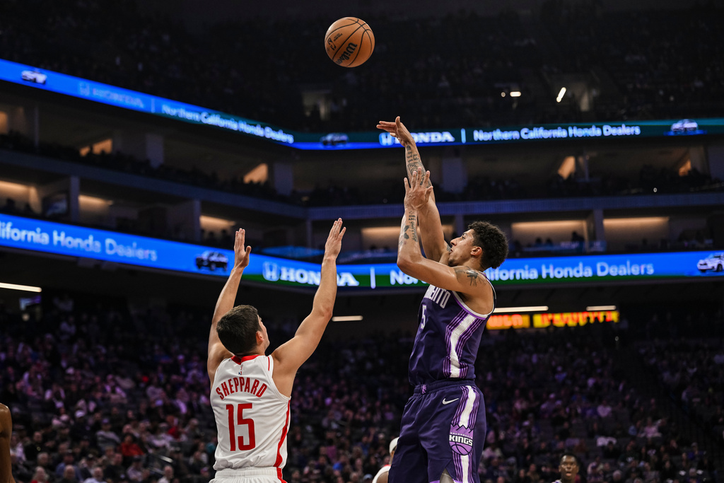 Sacramento Kings guard Nique Clifford (5) attempts a shot over Houston Rockets guard Reed Sheppard (15) during the first half an NBA basketball game, Sunday, Dec. 21, 2025, in Sacramento, Calif. (AP Photo/Justine Willard)