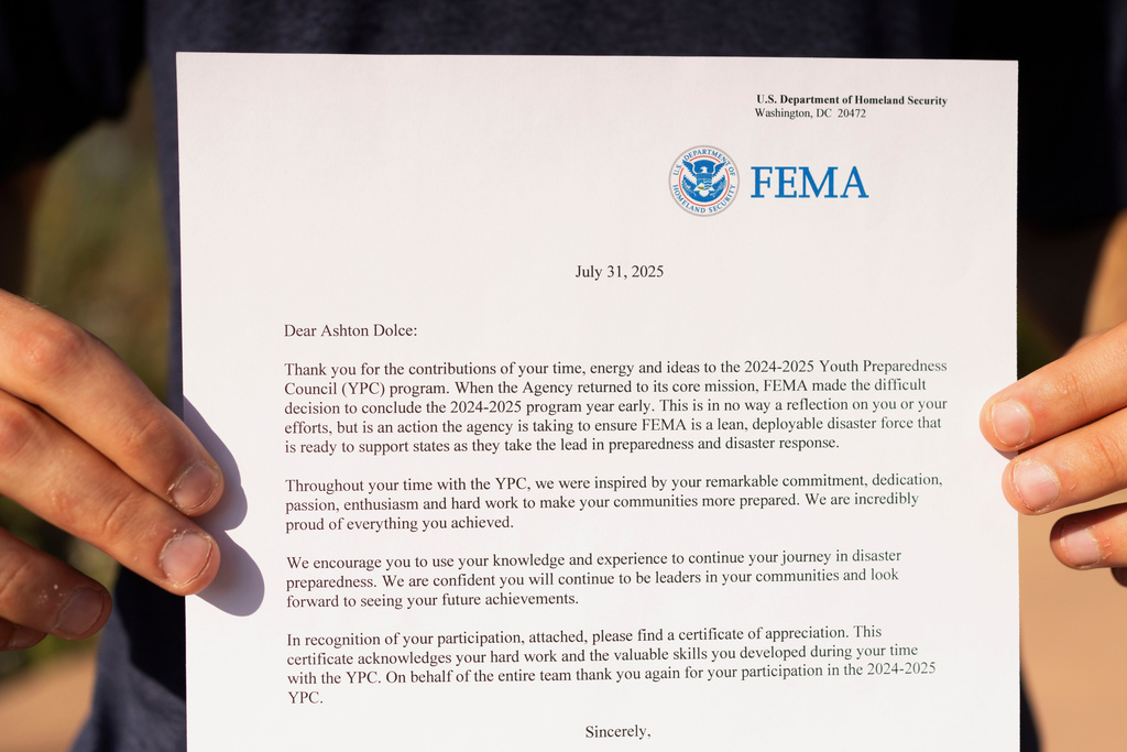 Ashton Dolce holds a letter from FEMA explaining the early termination of the Youth Preparedness Council at Cholla Park on Saturday, Aug. 9, 2025, in Scottsdale, Ariz. (AP Photo/Rebecca Noble)
