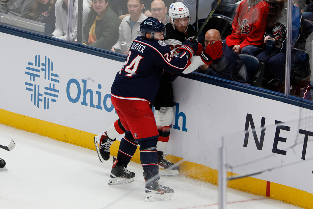 Columbus Blue Jackets' Mathieu Olivier, left, checks New Jersey Devils' Brett Pesce, right, during the third period of an NHL hockey game, Monday, Oct. 13, 2025, in Columbus, Ohio. (AP Photo/Jay LaPrete)