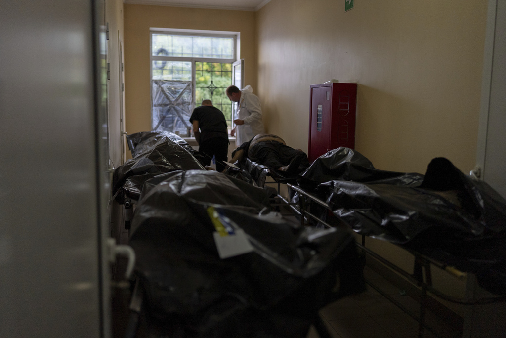 Bodies of civilians killed in a Russian aerial attack on village of Yarova, are seen at a morgue in Donetsk region, Tuesday, Sept. 9, 2025. (AP Photo/Alex Babenko)