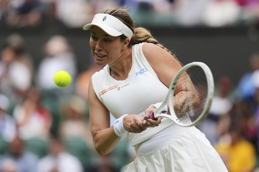 FILE - Danielle Collins of the U.S. returns to Iga Swiatek of Poland during a third round women's singles match at the Wimbledon Tennis Championships in London, Saturday, July 5, 2025. (AP Photo/Kirsty Wigglesworth, file)