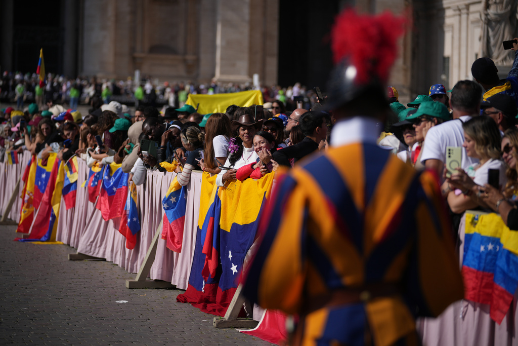 Faithful and pilgrims from Venezuela listen to Pope Leo XIV presiding over a Mass in St. Peter's Square at the Vatican, during which he canonized seven new saints of the Catholic Church, Sunday, Oct. 19, 2025. (AP Photo/Andrew Medichini)
