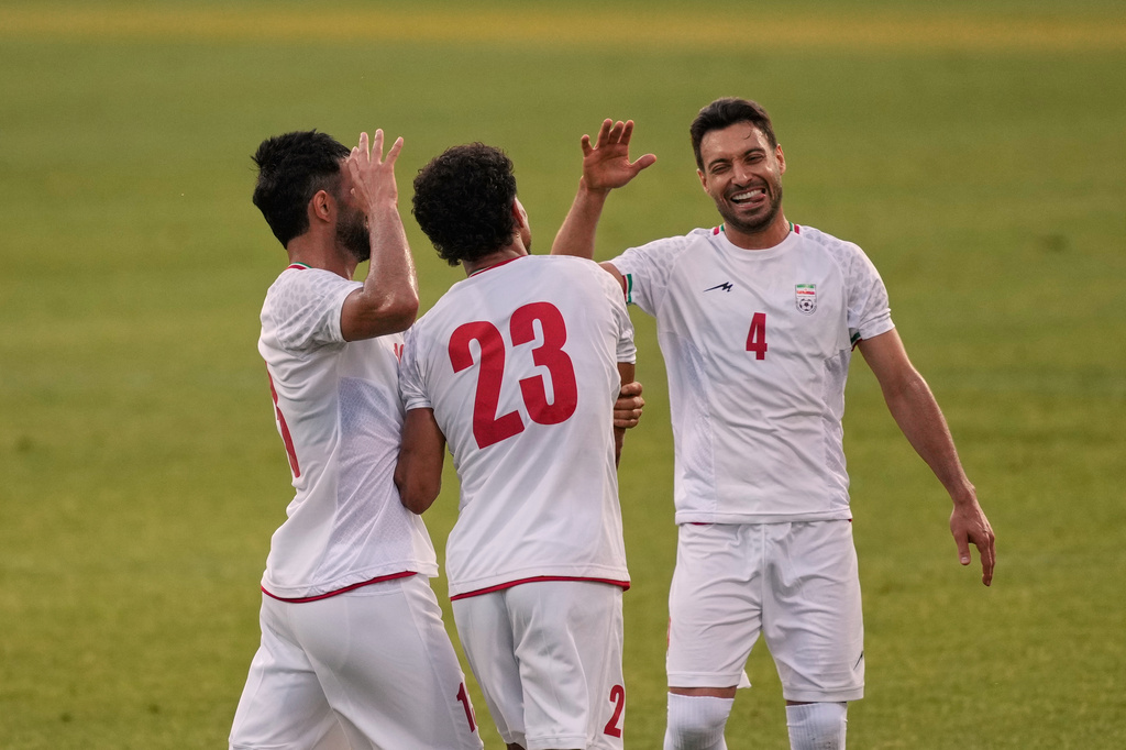 Iran's Ramin Rezaeian, center, celebrates with teammates after scoring their side's second goal during a friendly soccer match between Iran and Gambia, in Antalya, southern Turkey, Friday, May 29, 2026. (AP Photo/Khalil Hamra)