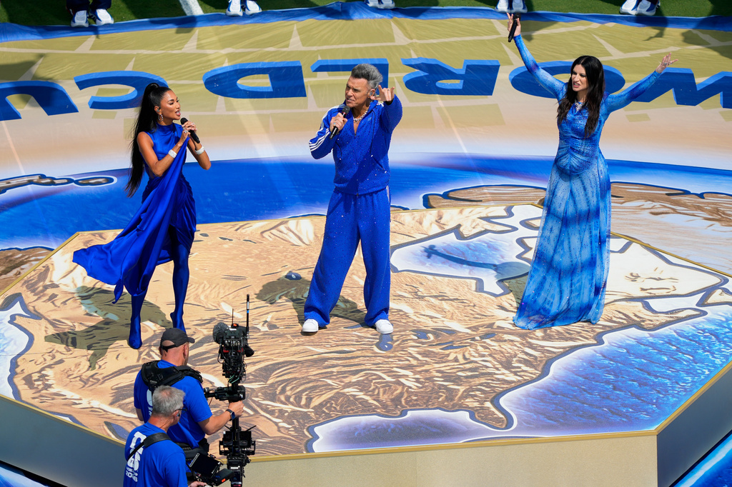 From left: Nicole Scherzinger, Robbie Williams and Laura Pausini perform prior to the World Cup final soccer match between Spain and Argentina in East Rutherford, N.J., near New York, Sunday, July 19, 2026. (AP Photo/Yuki Iwamura)