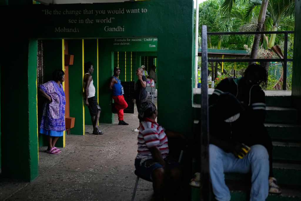 People take shelter at a school ahead of Hurricane Melissa's forecast arrival in Old Harbour, Jamaica, Monday, Oct. 27, 2025. (AP Photo/Matias Delacroix)