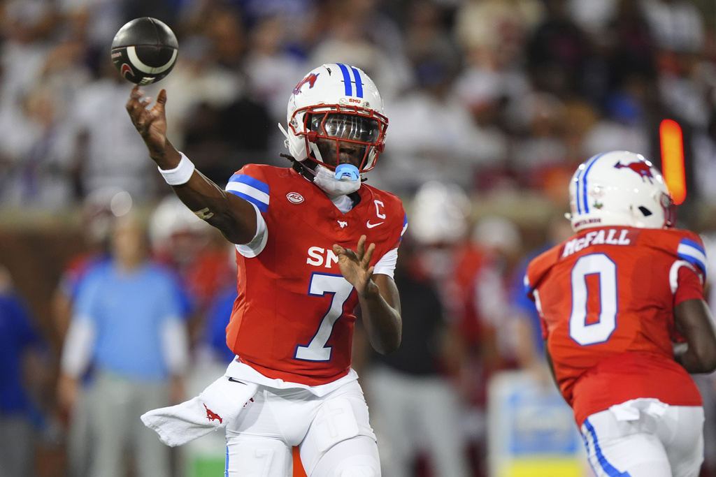 SMU quarterback Kevin Jennings (7) passes after faking a hand-off to running back Derrick McFall (0) during the first half of an NCAA college football game against East Texas A&M Saturday, Aug. 30, 2025, in Dallas. (AP Photo/LM Otero)