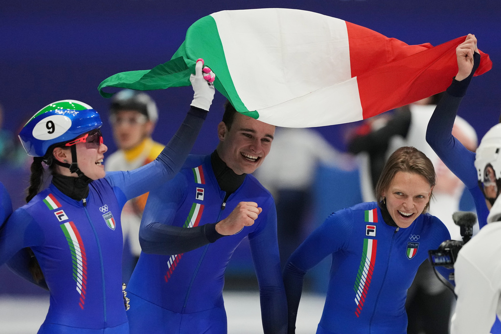Team Italy celebrate as they take the gold in the team mixed relay short track speed skating at the 2026 Winter Olympics, in Milan, Italy, Tuesday, Feb. 10, 2026. (AP Photo/Stephanie Scarbrough)