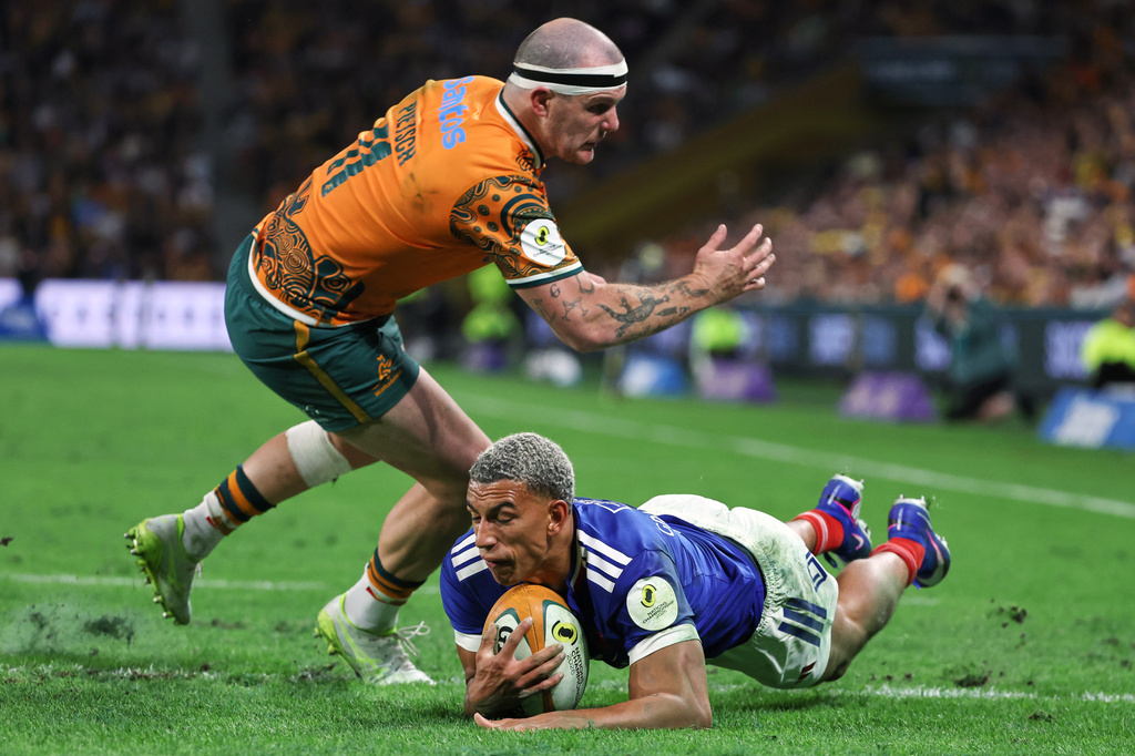 France's Aaron Grandidier-Nkanang scores a try under the attempted tackle of Australia's Dylan Pietsch during the Nations Championship rugby international between France and Australia in Brisbane, Australia, Saturday, July 11, 2026. (AP Photo/Tertius Pickard)