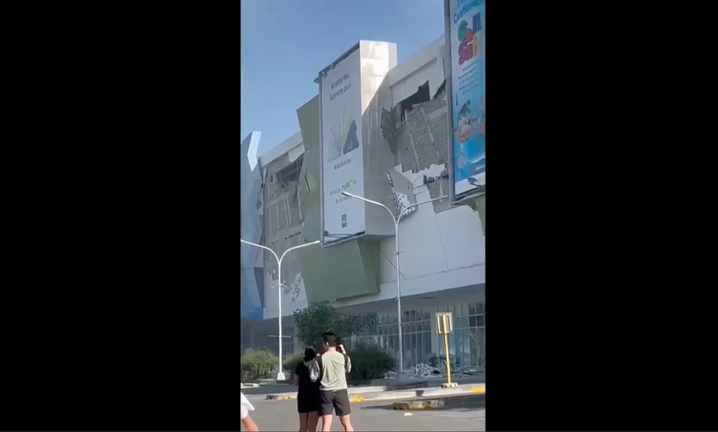 This image from a video shows people gathered outside a damaged building after a powerful earthquake in General Santos city on the island of Mindanao, Philippines Monday, June 8, 2026. (Ernesto Torres Jr via AP)