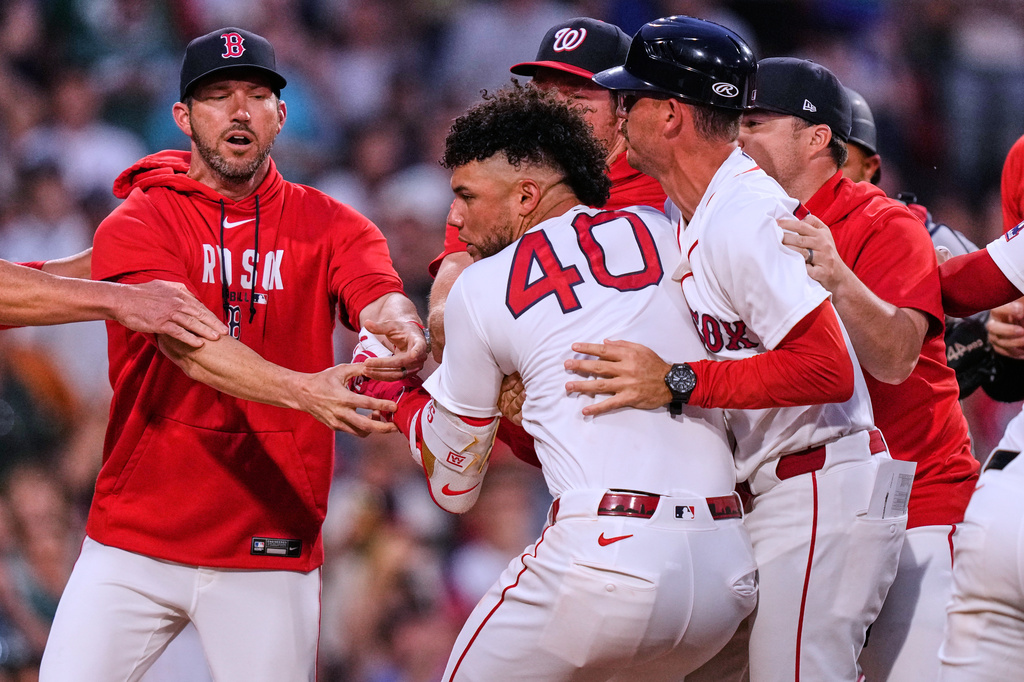 Boston Red Sox's Willson Contreras (40) is held back as tempers flare during the fourth inning of a baseball game against the Washington Nationals, Tuesday, June 30, 2026, in Boston. (AP Photo/Charles Krupa)