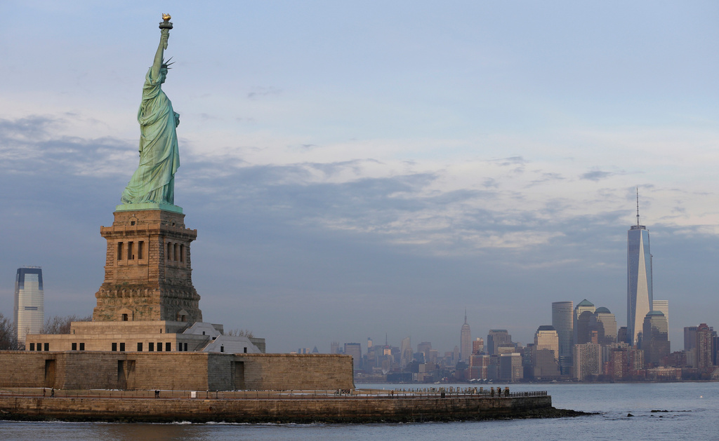 FILE - The lower Manhattan skyline, including the new One World Trade Center building at right, is shown as viewed from near the Statue of Liberty, Jan. 31, 2014, in New York. (AP Photo/Ted S. Warren, File)