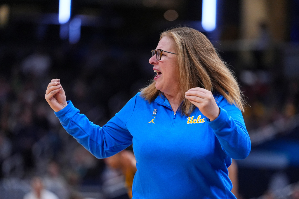 UCLA head coach Cori Close gesture in the second half of an NCAA college basketball game against Iowa in the finals of the Big Ten Conference tournament, Sunday, March 8, 2026 in Indianapolis. (AP Photo/Michael Conroy)