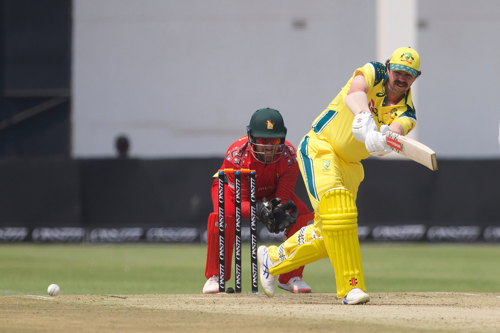 Australia's Travis Head, right, plays a shot as Zimbabwe wicketkeeper Brendan Taylor watches during the second one-day international cricket match between Zimbabwe and Australia in Harare, Zimbabwe, Friday, Sept. 18, 2026. (AP Photo/Wonder Mashura)