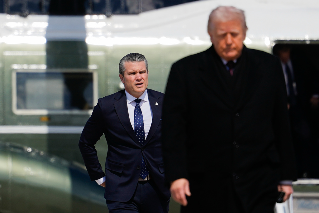Defense Secretary Pete Hegseth follows President Donald Trump to board Air Force One, Wednesday, March 18, 2026, at Joint Base Andrews, Md. (AP Photo/Julia Demaree Nikhinson)